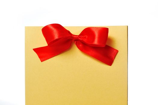 festive gold box with a red bow on a white background.