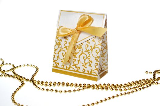 white box with festive ornaments and golden ribbon and beads.