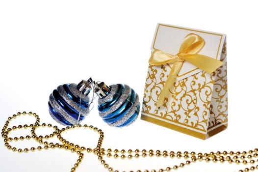 white box with festive ornaments and golden ribbon, beads and balls.