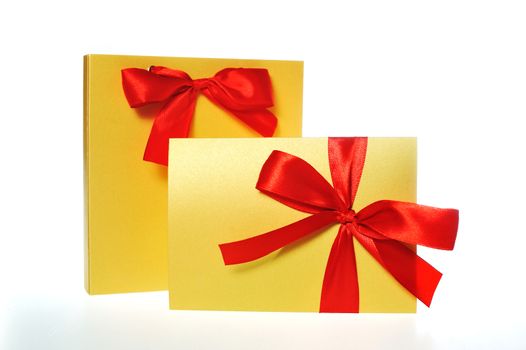 festive gold box with a red bow on a white background.
