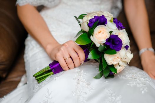 Beautiful wedding bouquet in hands of the bride