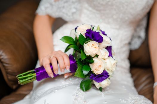 Beautiful wedding bouquet in hands of the bride