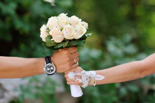 groom gives the bride a bouquet of roses