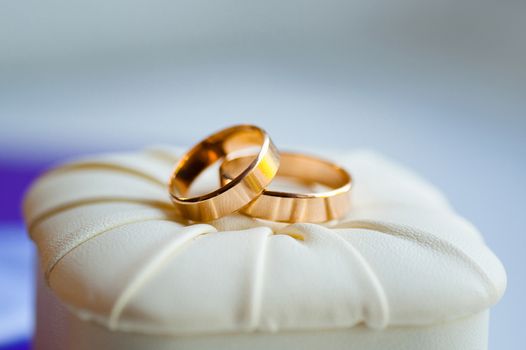 gold wedding rings on the pincushion