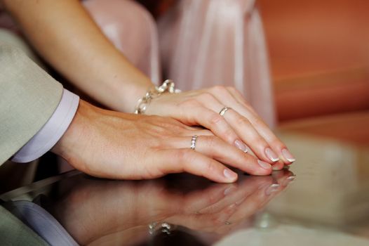 hands of the bride and groom together