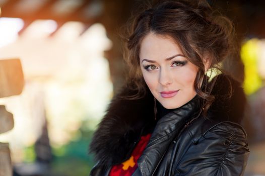 Portrait of a beautiful young brunette woman on blue background.