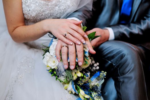 Hands on wedding bouquet