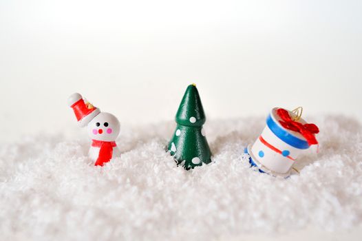 toy snowman tree and gift on snow