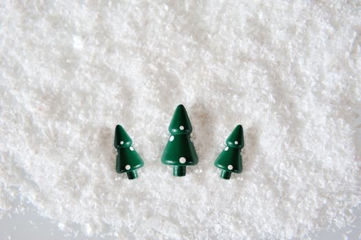 Three Miniature Christmas Trees on snow
