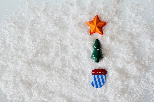 Christmas toys on white snow background
