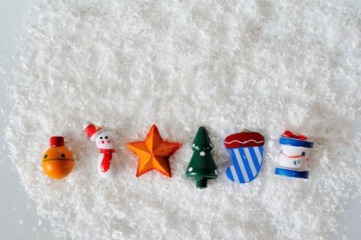 Christmas toys on white snow background