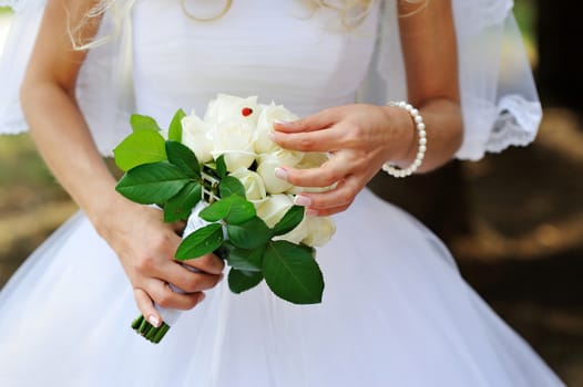 bridal bouquet of white roses in bride's hands