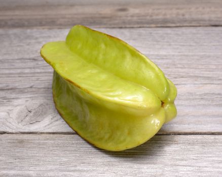 Star fruit - carambola isolated on wooden table