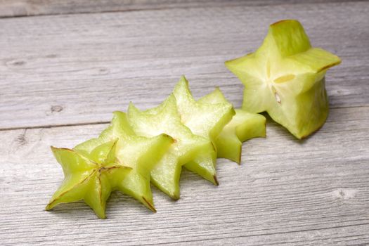 Star fruit - carambola isolated on wooden table