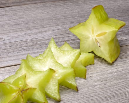 Star fruit - carambola isolated on wooden table