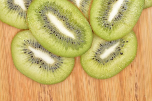 Sliced kiwi fruit on wood table.