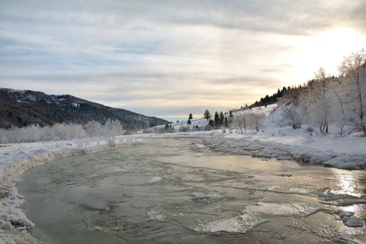 Frozen river and trees in winter season.