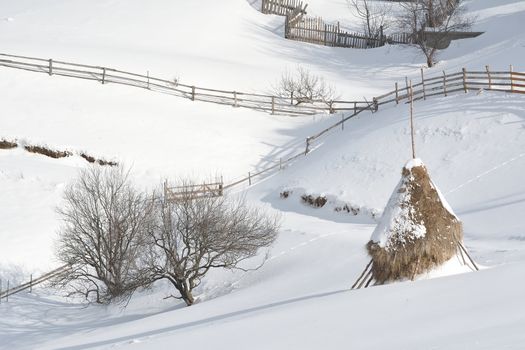 Haystack in winter mountains.