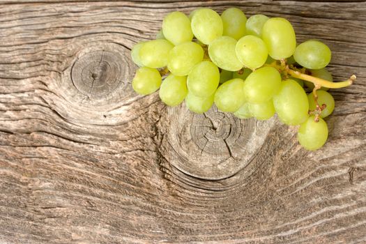 green grapes on wooden background