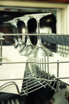 details of Open dishwasher with clean utensils