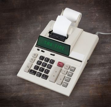 Old calculator showing a text on display - tax time