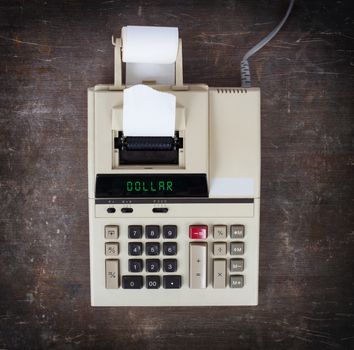 Old calculator showing a text on display - dollar