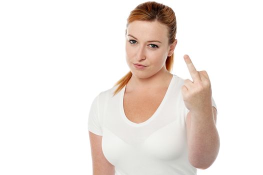 Young woman making fuck you gesture