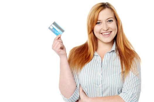Happy woman showing a cash card to camera