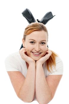 Young happy woman is lying on the floor