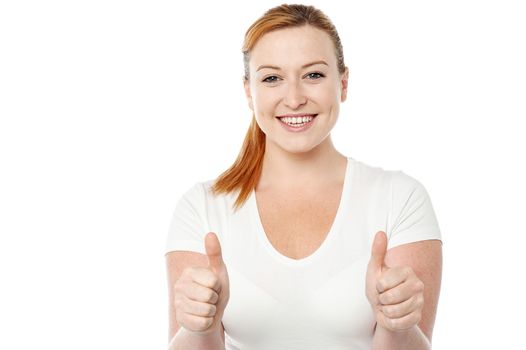 Smiling woman making thumb up gesture