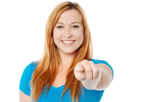 Cheerful woman pointing her finger at camera