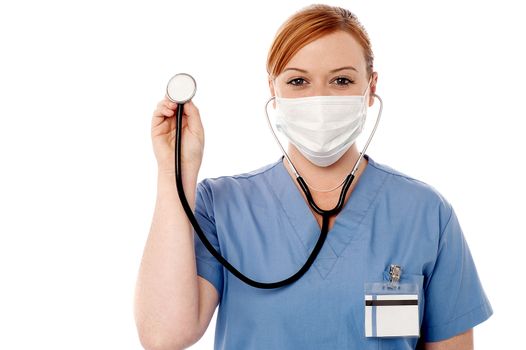 Female doctor holding up a stethoscope 