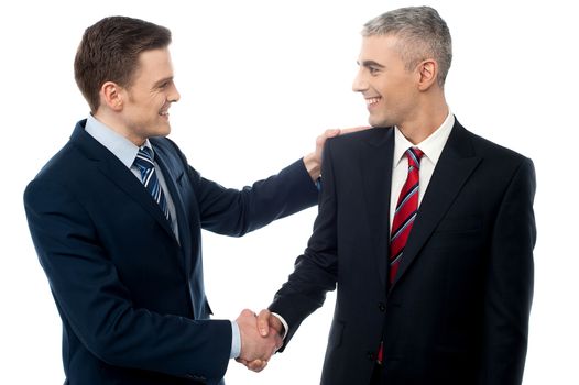 Happy young businessmen shaking hands