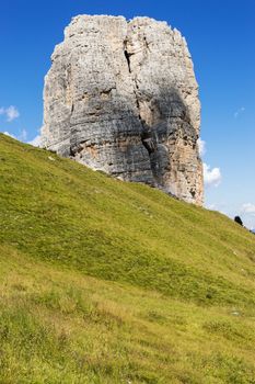 Five Tower, Dolomites: the big tower and meadow with blue sky background in a clear summer afternoon