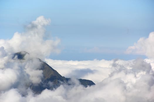 Landscape high mountain peaks covered with clouds