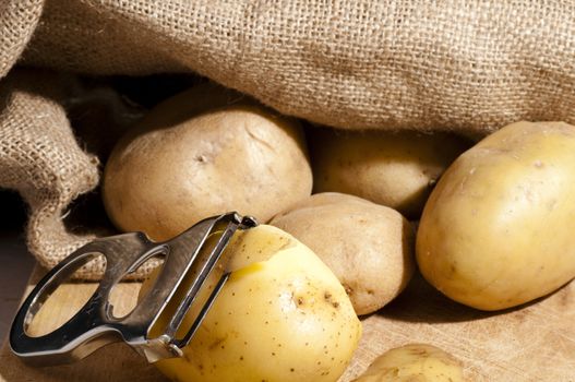 potatoes that are out of the jute bag ready to be peeled