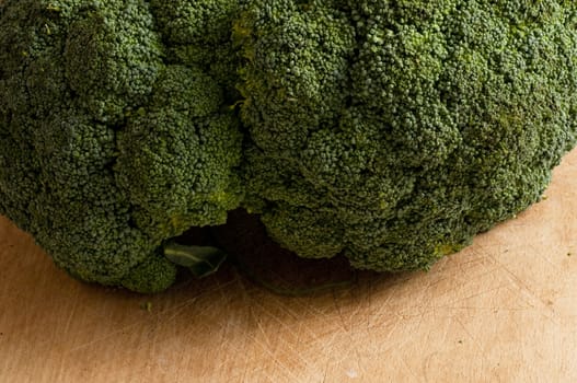 detail of a fresh broccoli on a wooden board