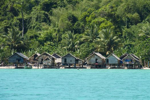The Moken Sea Gypsy Village at Koh Surin Tai in the Mu Ko National Park, Surin Islands of Thailand with its thatched houses on stilts.