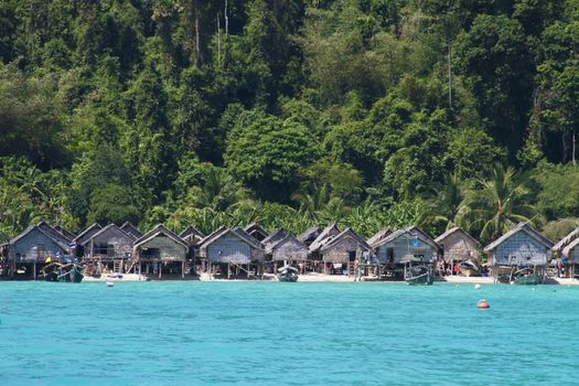The Moken Sea Gypsy Village at Koh Surin Tai in the Mu Ko National Park, Surin Islands of Thailand with its thatched houses on stilts.