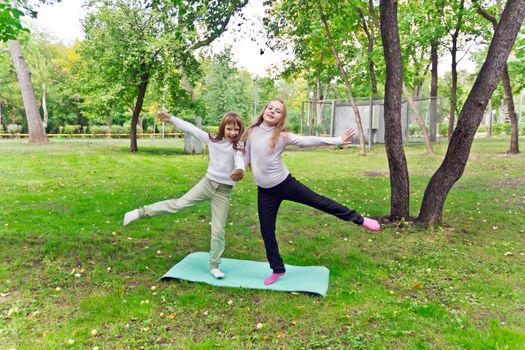 Photo of two playing girls in summer