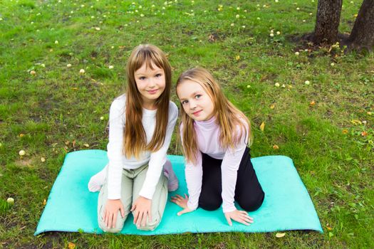 Photo of two playing girls in summer