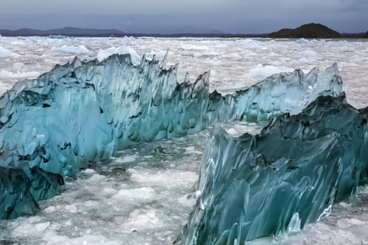 Dense, green amorphus glacial ice floating in Laguna San Rafael near the San Rafael Glacier in  in the Northern Patagonian Ice Field in southern Chile, South America. 