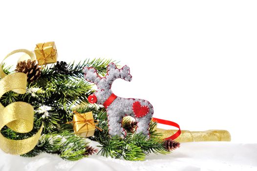 Christmas deer made ​​of felt on the background of Christmas tree with gifts