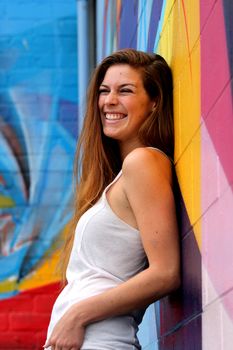 Young woman standing in front of a colorful background.