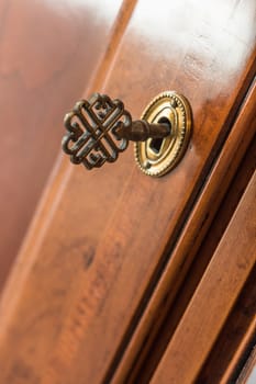 closeup of old iron key in the lock