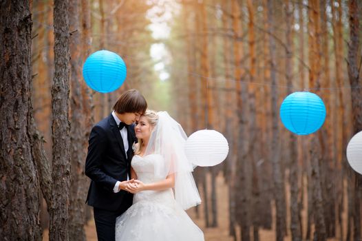 bride and groom in forest decorated