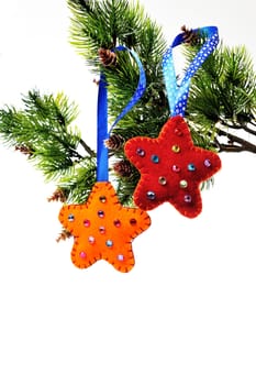 Two stars out of felt toys on a Christmas tree