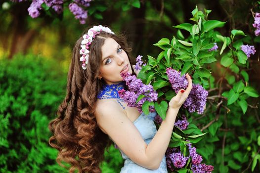 Women with lilacs with a wreath on head