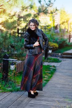 Portrait if young woman walking in spring park.