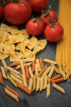 food background on rustic wood with pasta and tomatoes